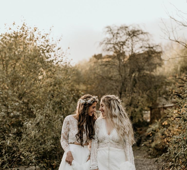 LGBTQIA+ wedding with two brides in long sleeve lace wedding dresses for boho wedding 