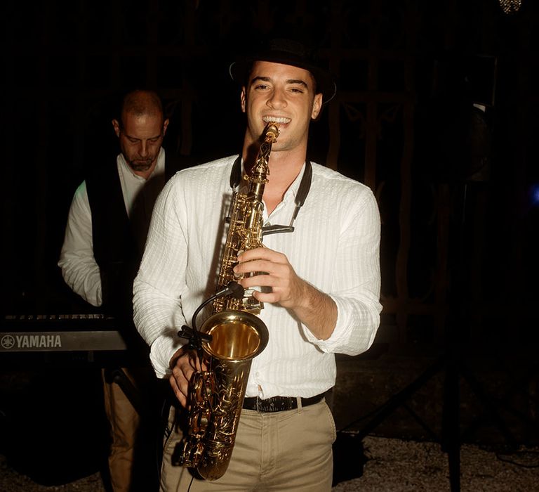 Saxophone player plays tune at wedding reception 