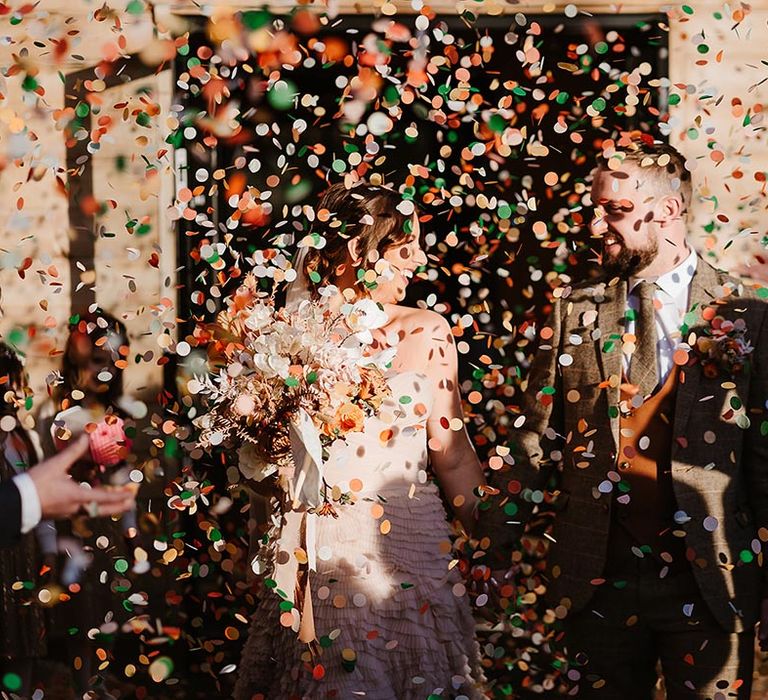 Bright and colourful confetti exit for bride and groom after their ceremony with confetti from Flutter, Darlings! 