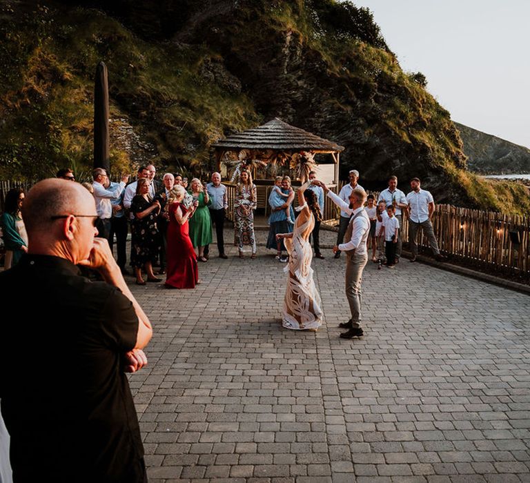 Bride and groom have their first dace outdoors during summer coastal wedding 