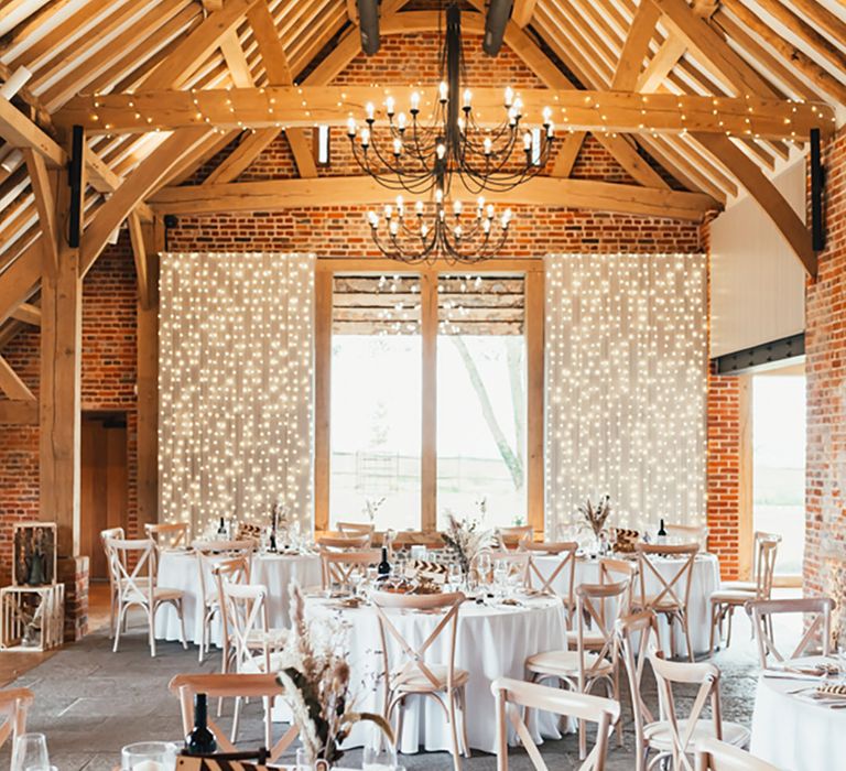 Rackleys Barn wedding venue decorated for the rustic cinema inspired wedding with dried flowers and fairy lights 