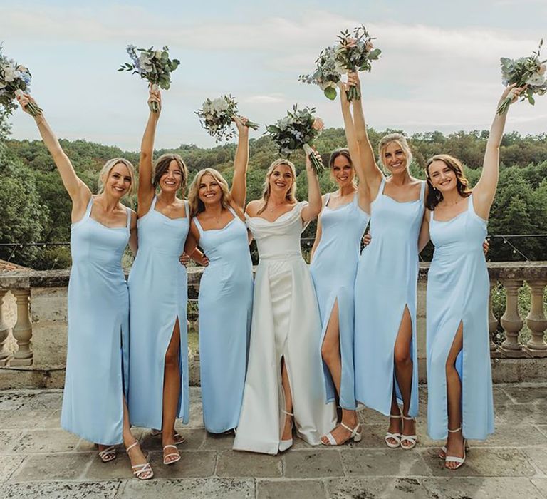 Bridesmaids in blue bridesmaid dresses with front slit at Chateau wedding 