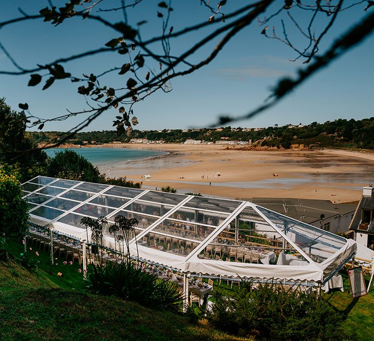 Outdoor glass marquee at home wedding for bride and groom 