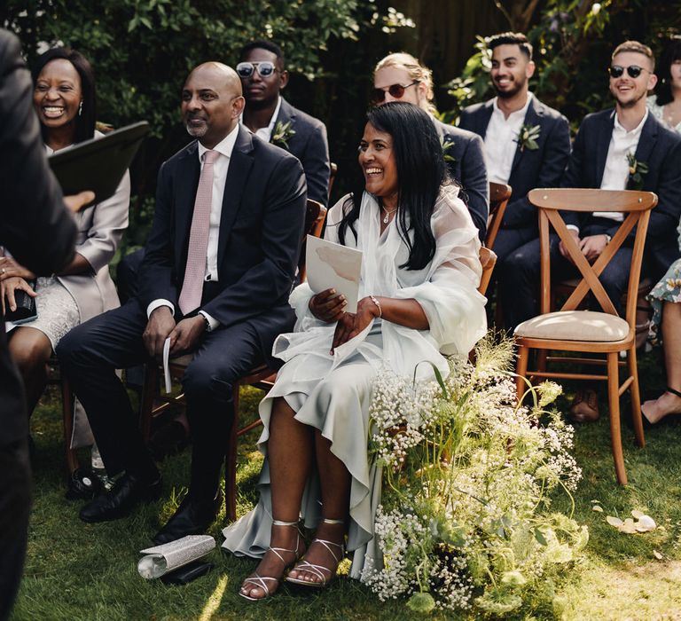 Mother and father of the groom at outdoor garden wedding 