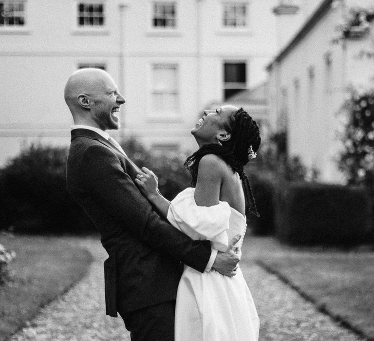 Bride and groom laughing at Morden Hall wedding 