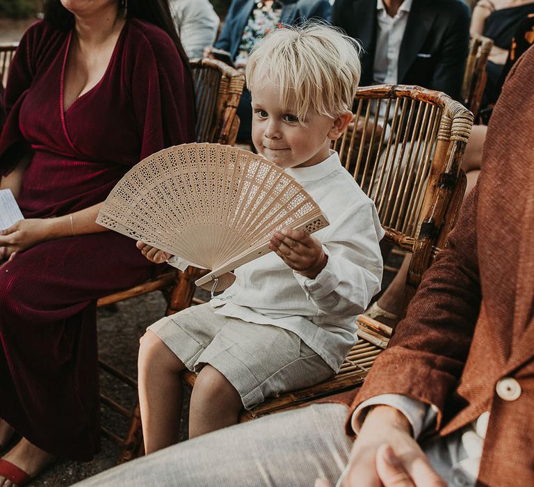 Page boy with wooden fan favour for Andalusia wedding