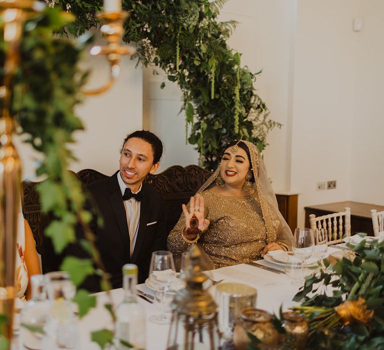 Bride and groom smiling during the wedding reception speeches 