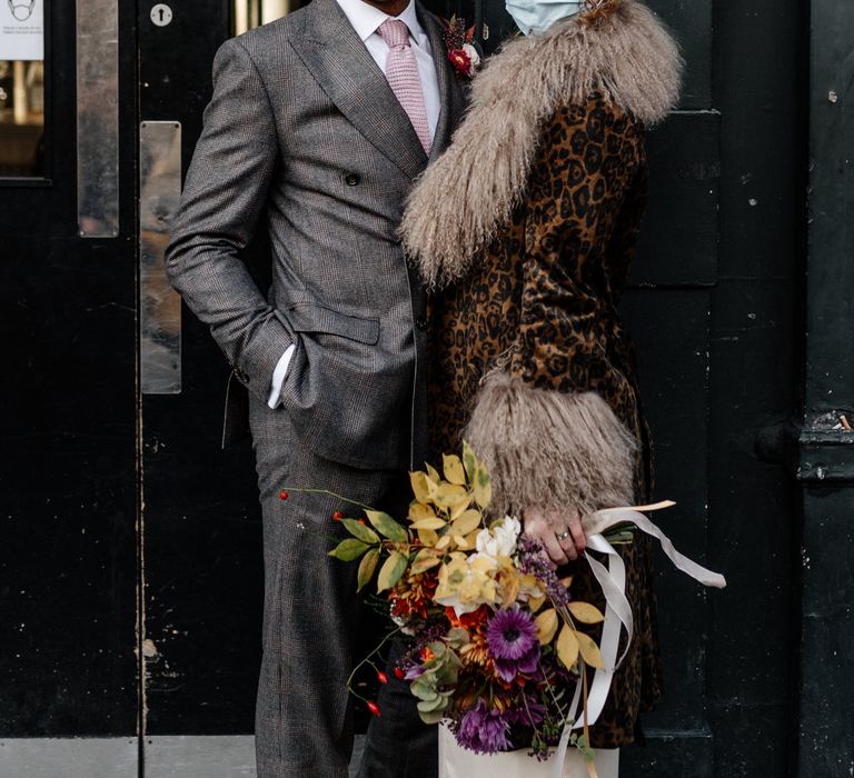 Bride and groom wear face masks at micro wedding in London