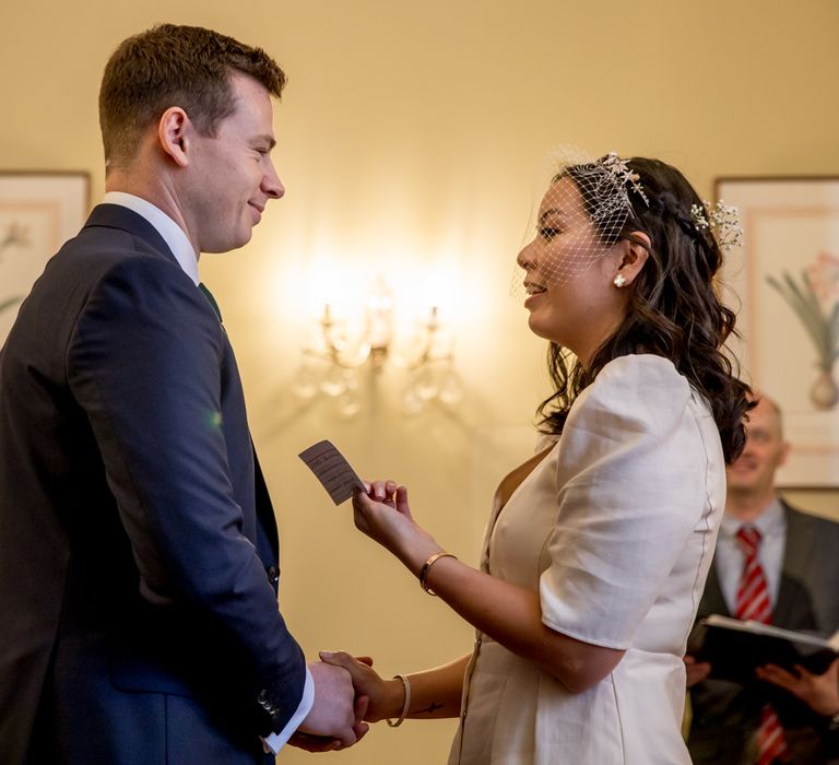 Bride and groom exchanging vows at Chelsea Old Town Hall 