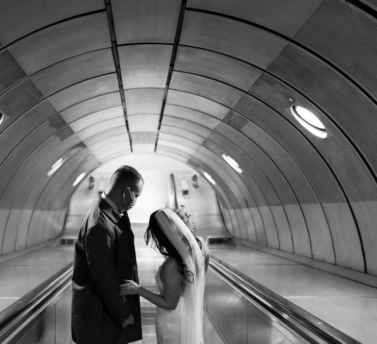 Bride and groom on London tube escalator 