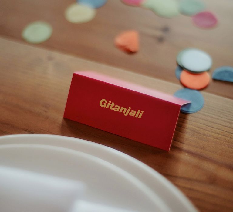 Colourful name place cards and confetti table decor 