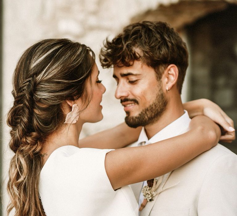 Boho bride with a hal up half down braided updo and open back bridal top 