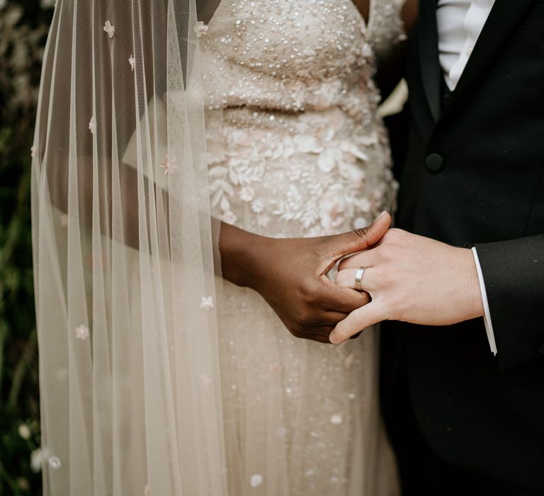 Black bride and white groom holding hands at intimate elopement 