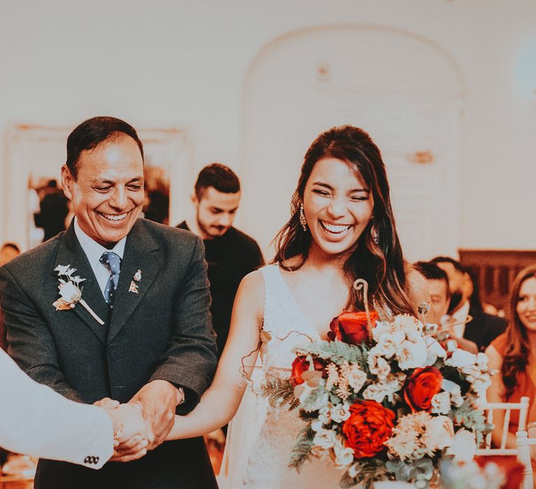 Bride walks down the aisle with father on her wedding day