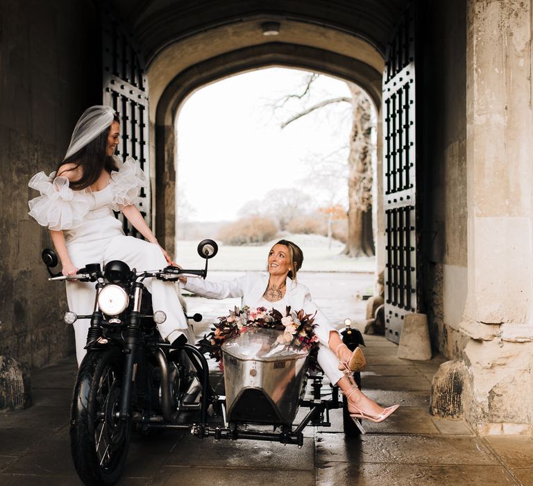 Bride and Bride sitting in a wedding sidecar and motorbike at Ashridge House stately home 