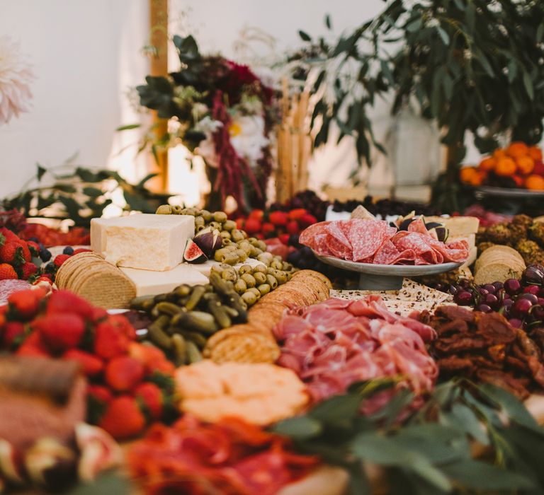 Grazing table featuring meats, cheeses and olives