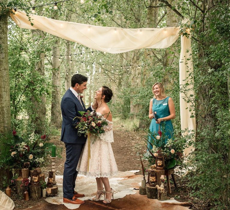 Bride & groom look lovingly at one another during vow renewal 