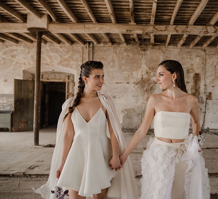 Two brides in a mini wedding dress and bridal separates for a romantic industrial wedding 