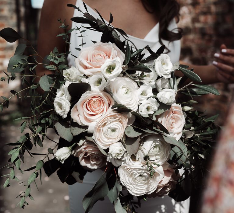 Large bouquet of white and blush pink roses for romantic and intimate church micro wedding