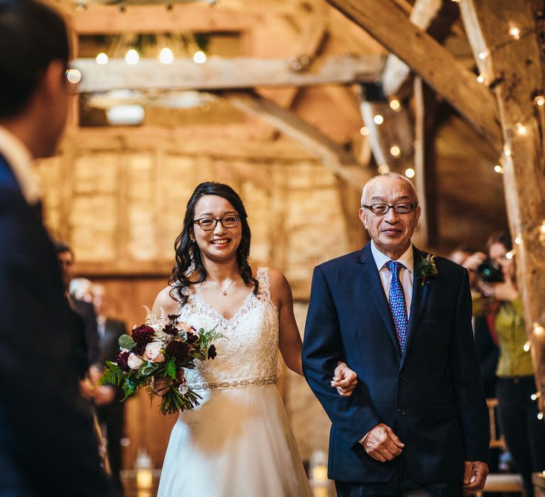 Bride walks down the aisle with her father on her wedding day