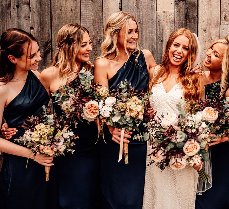 Bride with bridesmaids all holding artificial wedding bouquets