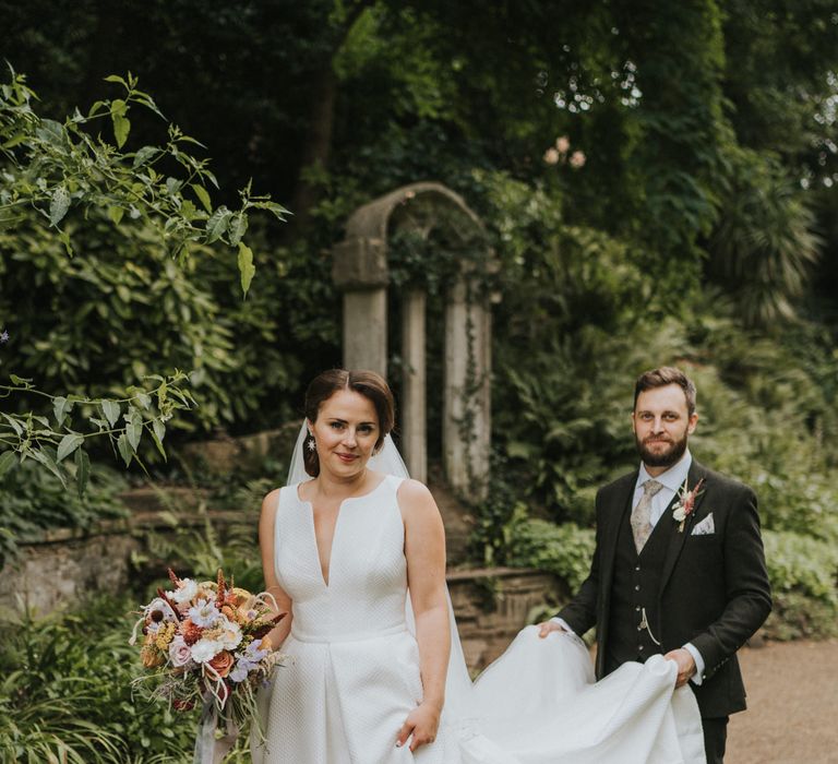 Groom carries brides Jesus Peiro wedding dress at Norwich wedding