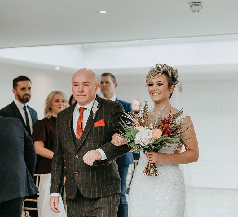 Bride walks down the aisle with her father