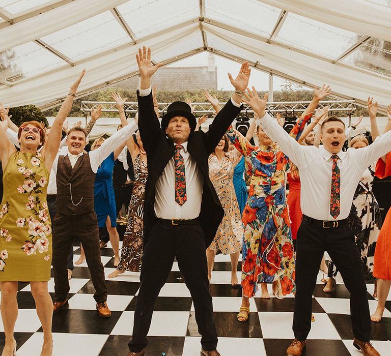 Surprise flash mob dance in a clear marquee at back garden wedding 