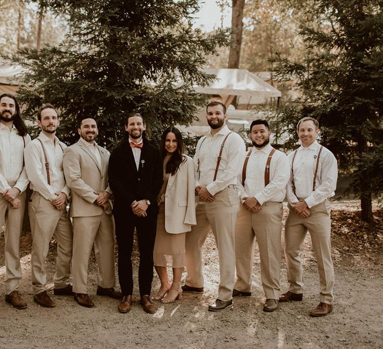 Groom stands with his groomsmen on his wedding day