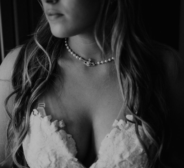 Bride wears pearl and diamanté Vivienne Westwood necklace and sweetheart wedding gown