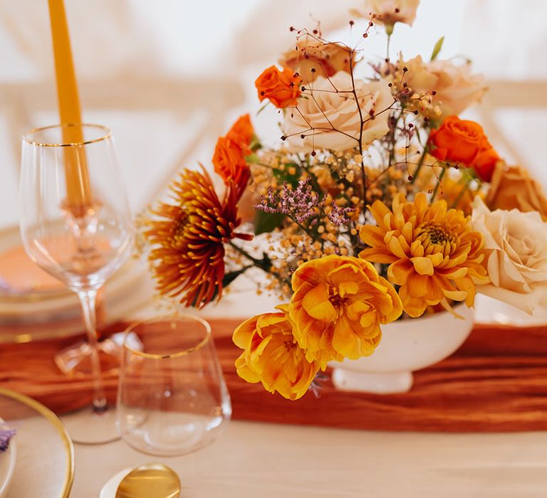 golden blush pink, orange and yellow wedding flower arrangement 