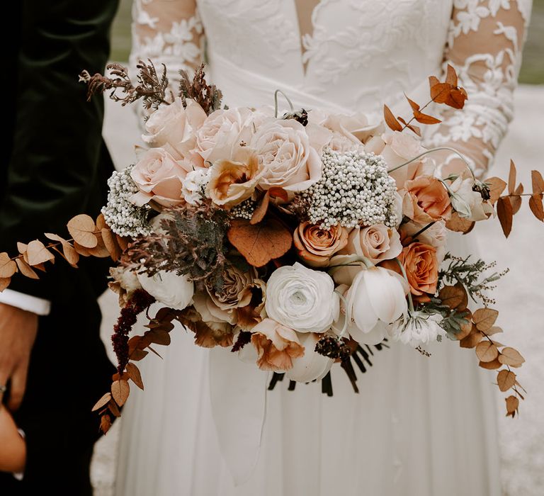 Bridal bouquet with roses, peonies and autumn leaves