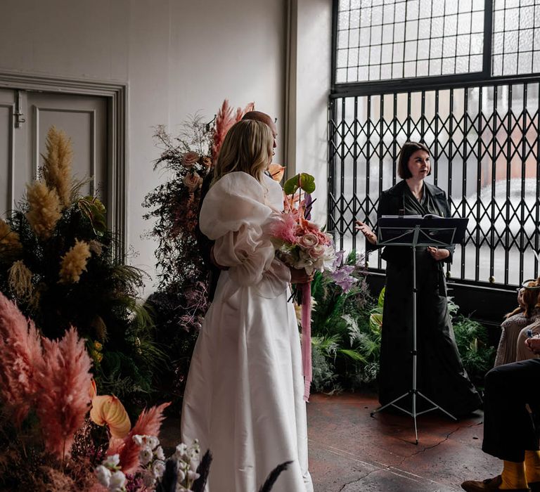 Humanist wedding ceremony at Floral Hall with column flowers decorating the altar 