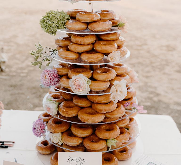 Krispy Kreme doughnut tower complete with floral decor