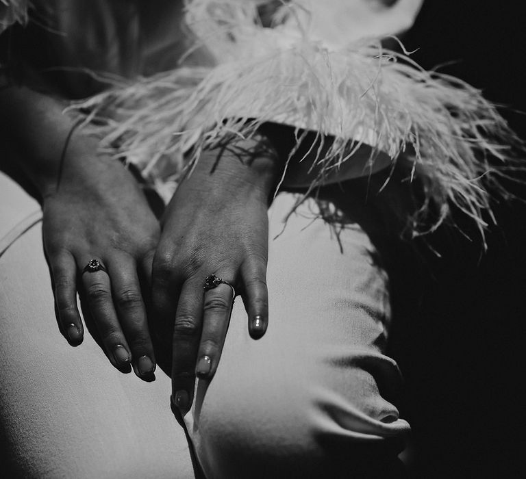 Bride in white pyjamas with feather cuffs