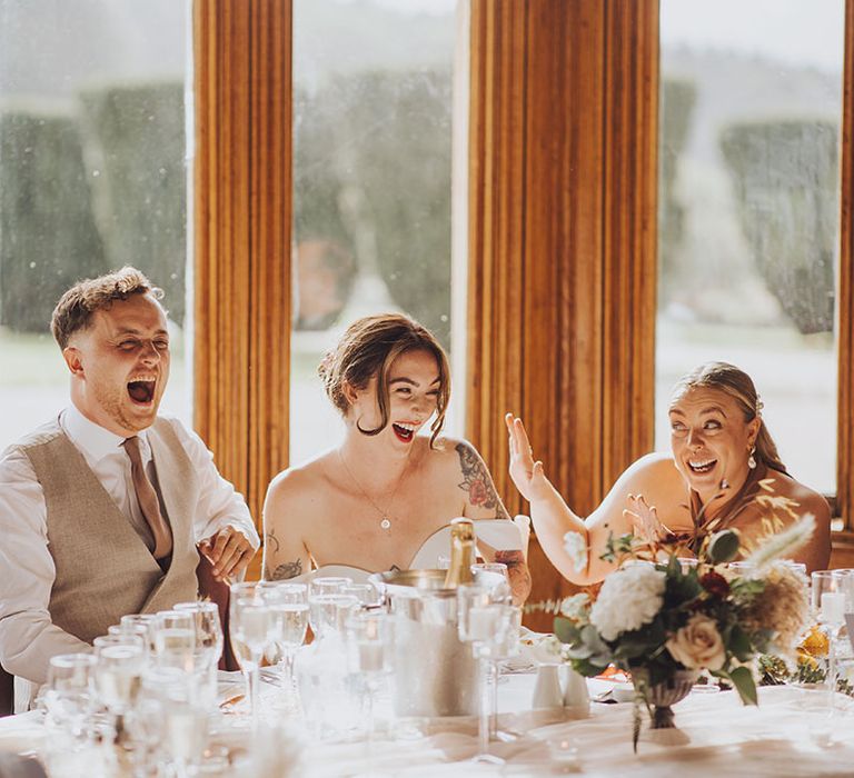 bride & groom laugh during wedding reception speeches at St Audries Park