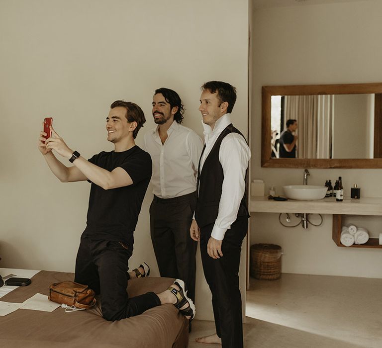 Groom & his groomsmen take selfies on the morning of his wedding day