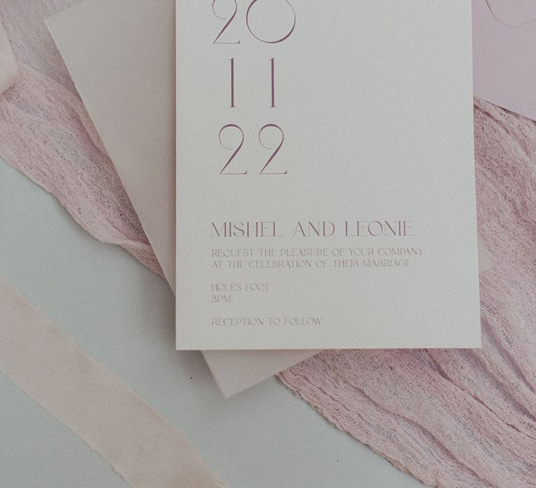 Minimalistic style wedding invitation with simple lilac lettering on white paper