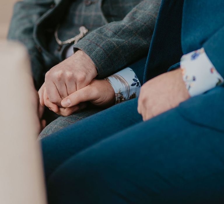 Grooms wear tartan suit and blue suit complete with floral shirts for wedding in Kew Gardens 