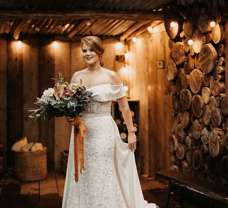 Bride wears Love Spell wedding dress with embroidered floral design and white skirt to back