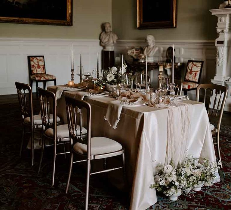 intimate wedding reception at Capesthorne Hall with gold rimmed glassware and tablecloth