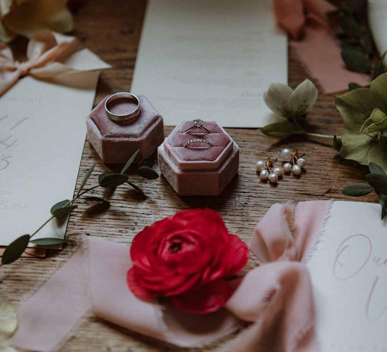 Red garden rose wedding decor with dusky pink velvet wedding ring box, pearl earrings and foliage arrangements 