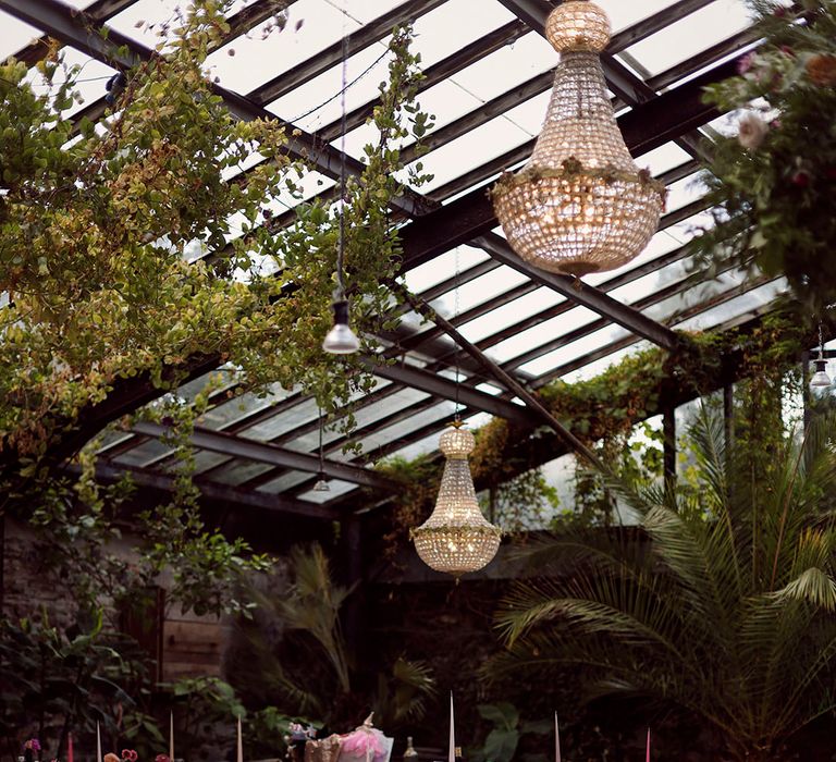 Anran wedding venue glasshouse with chandeliers and hanging flower installations 