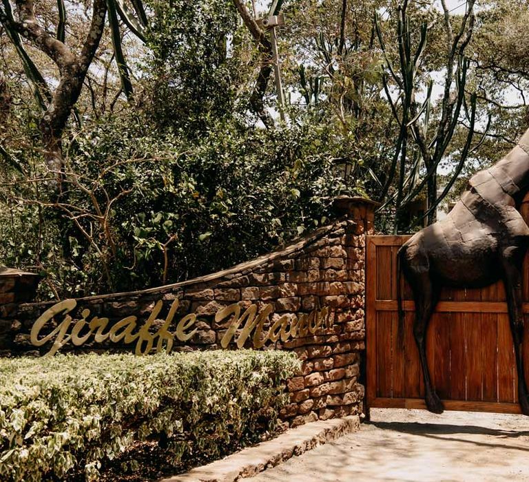 Exterior shot of the gates of Giraffe Manor wedding venue in Kenya