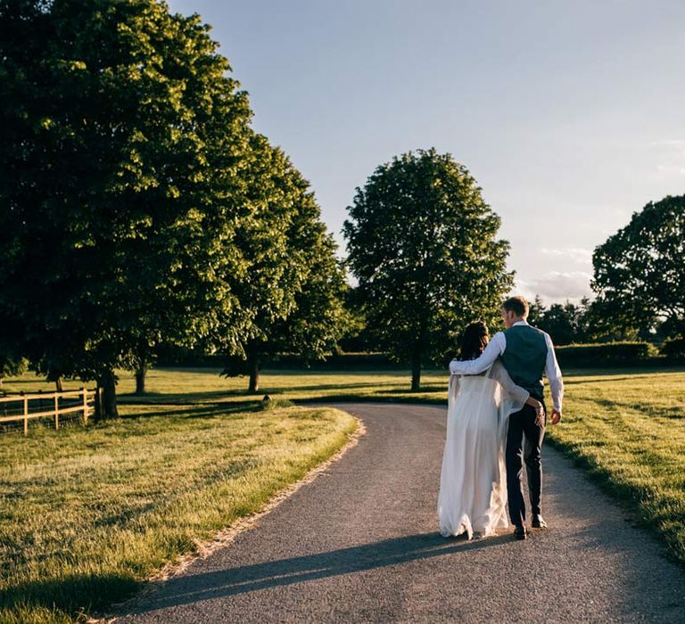 Bride and groom walking around Templars Barn wedding venue 