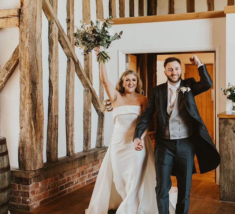 Villiers Barn Essex wedding venue with bride and groom entering their wedding reception 