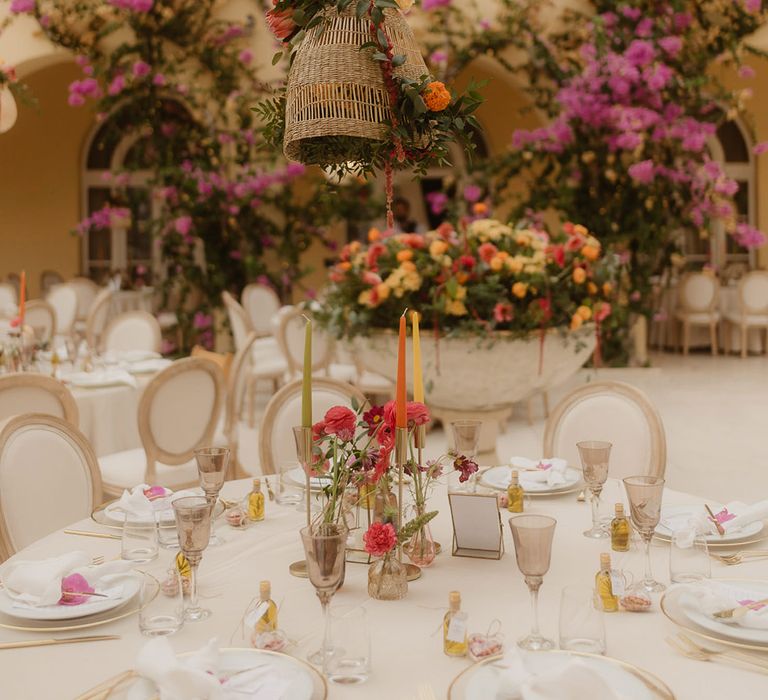 bright wedding table decorations for alfresco, Croatia wedding with coloured candles and flower stems in vases 