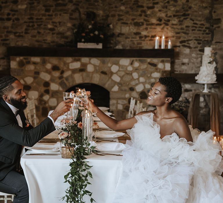 Bride and groom make a cheers to each other on their wedding day 