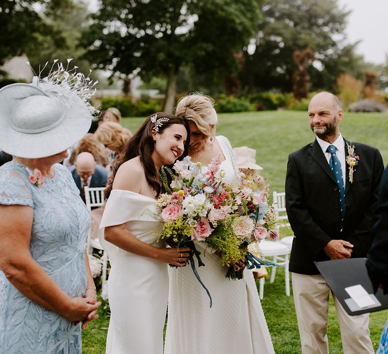 Two brides for their lesbian wedding and outdoor ceremony during summer 