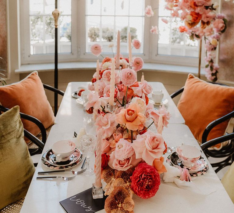 Roses and dahlias pink and peach wedding flower table decor with twisted candles 